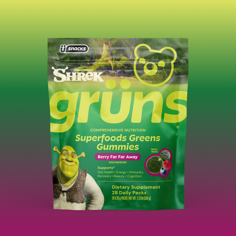 Green Grüns Superfoods Greens Gummies package featuring the Shrek logo and character, labeled Berry Far Far Away flavor, listing support for gut health, energy, immunity, recovery, beauty, and cognition, Dietary Supplement, 28 Daily Packs, on a green-to-purple gradient background.