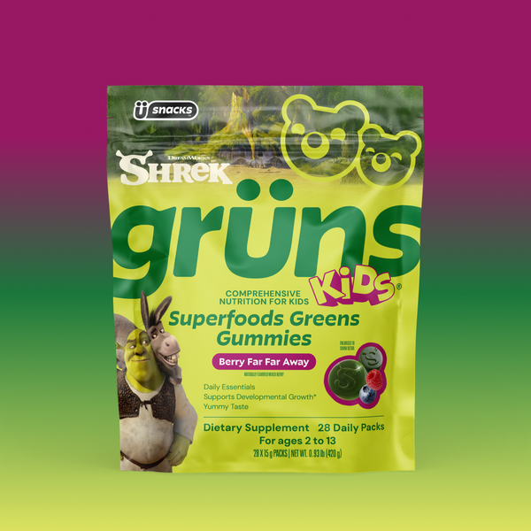 Yellow-green Shrek Kids Grüns Superfoods Greens Gummies package featuring Shrek and Donkey, labeled Berry Far Far Away flavor, listing Daily Essentials, Supports Developmental Growth, Yummy Taste, Dietary Supplement, 28 Daily Packs, for ages 2 to 13, on a purple-to-green gradient background.