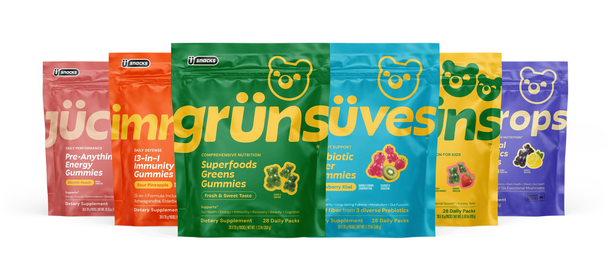 Six product packets from the Grüns supplement line in different colors and flavors, including pre-workout energy, immunity, superfoods greens, prebiotic fiber, kids, and mushroom gummies
