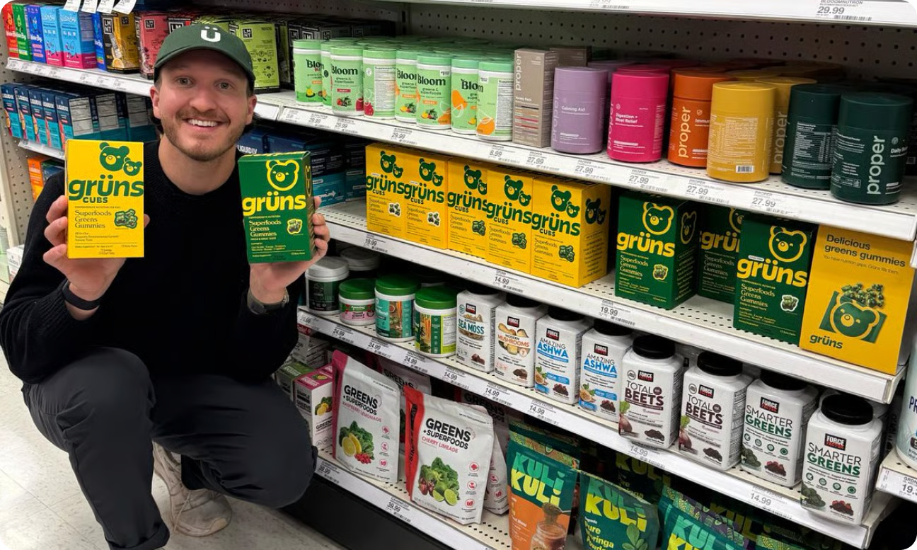 Founder Chad Janis in a store aisle holding Grüns