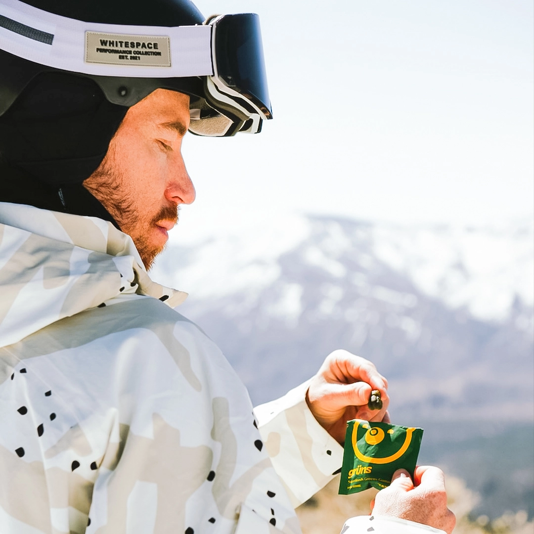 Shaun White eating Grüns while wearing snowboarding gear