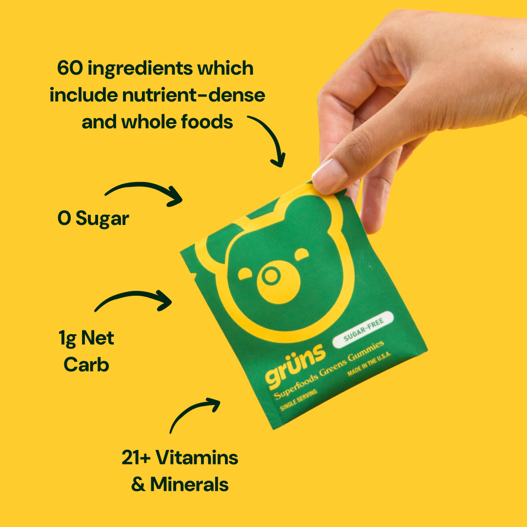 Hand holding a green packet with a bear logo and nutritional information.