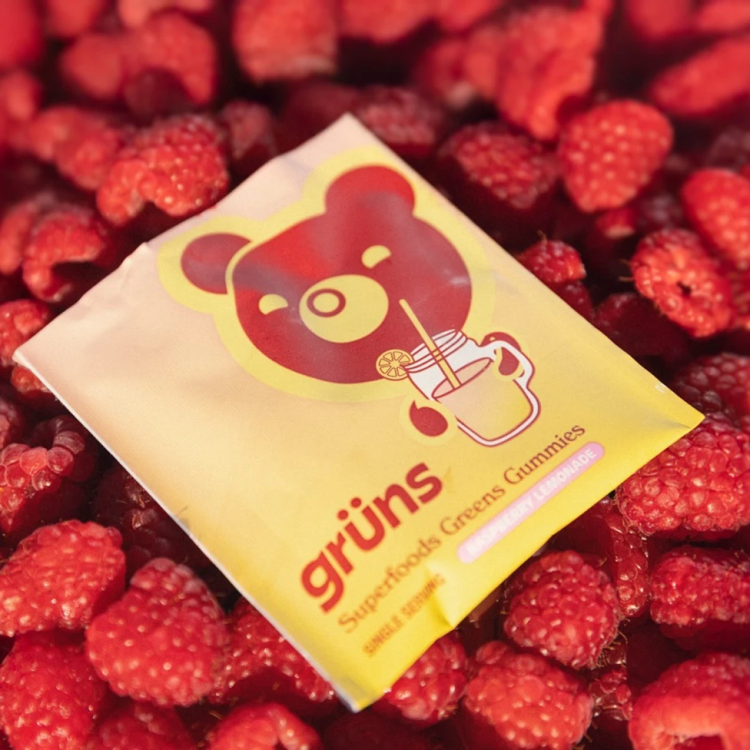 Grüns sachet sitting on a pile of raspberries