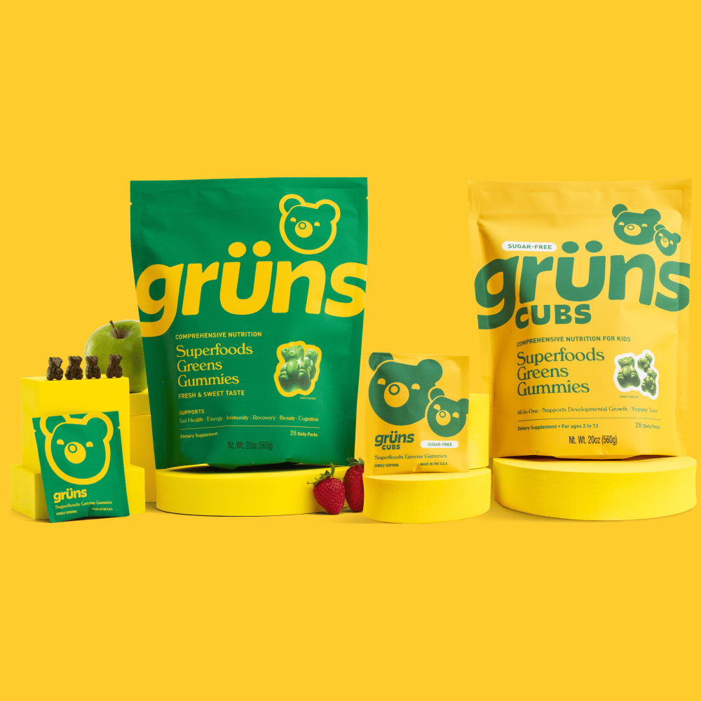Grüns Superfoods Greens Gummies packaging displayed on a bright yellow background.