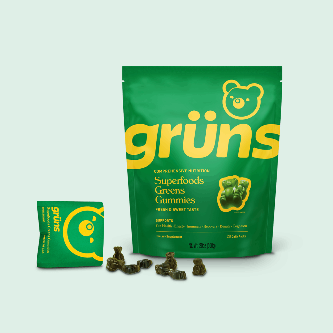 Green packaging of Grüns Superfoods Greens Gummies, with gummies displayed in front.