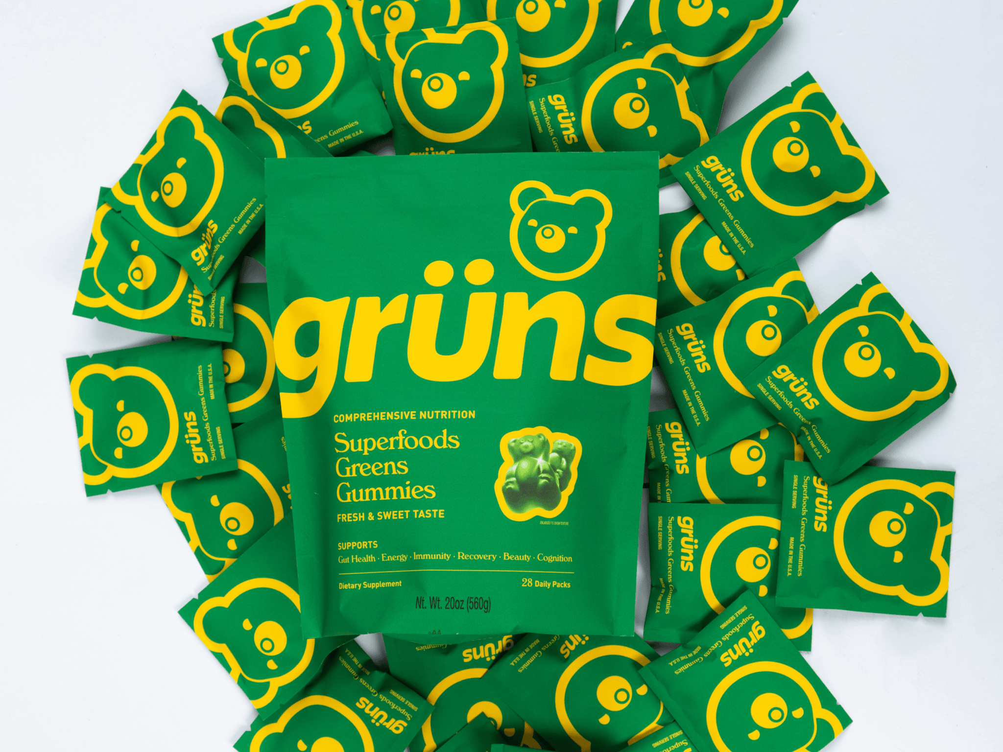 Green packaging of Grüns Superfoods Greens Gummies with bear logo.