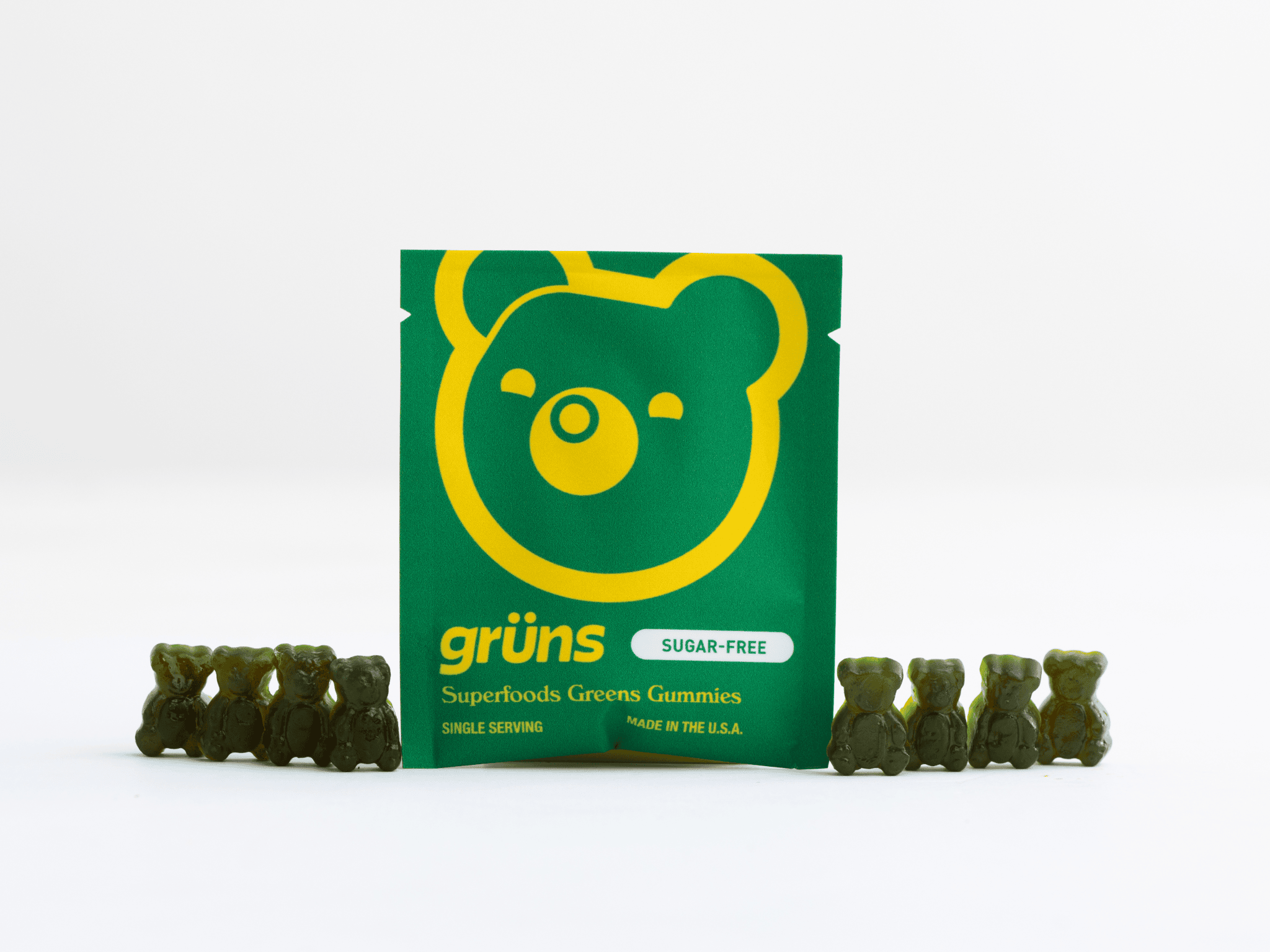 Green gummy bears with packaging featuring a bear design.